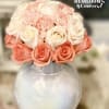 Pink and white rose bouquet in a clear round vase