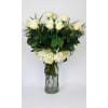 White roses and hydrangeas in a clear glass vase