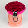 Bouquet of deep pink roses in a pink hatbox