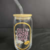 Clear glass tumbler with a bamboo lid and glass straw