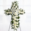 White floral cross wreath on a standing easel