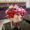 Pink and red floral arrangement in a glass vase