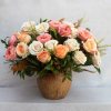 BOUQUET OF MIXED ROSES IN A GLAZED TERRACOTTA CONTAINER. 
ARRAY OF ROSES