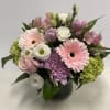 A lovely combination of pastels arranged in a compact pink gerberas, roses