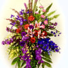 Tall mixed bouquet with red roses, pink lilies, and purple flowers