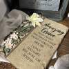 Decorative plaque with white flowers and a Bible verse