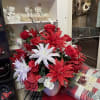 Red and white floral arrangement in a ribbed vase