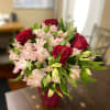 Bouquet of red roses and pale pink alstroemeria in a vase