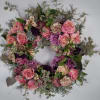 Pink and purple floral wreath with roses and mixed blooms