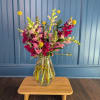 Mixed pink and magenta flowers in a clear glass vase