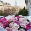 Bouquet of pink and pale roses with the Eiffel Tower in the background