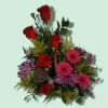 Mixed bouquet with red roses, pink gerbera daisies, and purple flowers