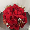 Round bouquet of red roses with small white filler flowers