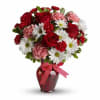 Bouquet of red roses, pink carnations, and white daisies in a red vase