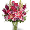Pink lilies and roses in a clear glass vase