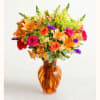 Colorful mixed bouquet in an amber glass vase