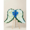 White floral standing spray with blue roses on a wooden easel