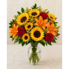 Sunflower and red rose bouquet in a clear glass vase