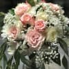 Bouquet of pink and white roses with baby's breath in a glass vase