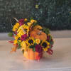 Pumpkin-shaped arrangement with sunflowers and roses