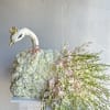White rose arrangement shaped like a swan with pink orchid sprays