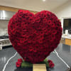 Heart-shaped arrangement of red roses on a kitchen counter
