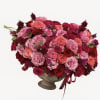 Large pink and red rose arrangement in a pedestal vase
