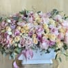 Large pastel bouquet of pink and cream roses in a white box