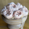 Pale pink roses arranged in a low round box