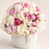 Pink and white peony bouquet in a white vase