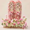 Pink rose floral display with ribbon lattice and matching flowers in a wooden base