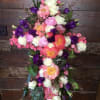 Cross-shaped floral arrangement with pink, white, and purple flowers