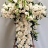 Large white rose cross arrangement on a wooden stand