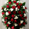 Large standing arrangement of red roses and white daisies