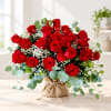 Bouquet of red roses with baby's breath in a burlap-wrapped base