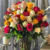 Large bouquet of multicolored roses in a clear glass vase