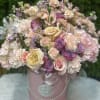 Pastel rose bouquet in a pink hatbox with ribbon
