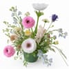 Mixed pastel flower arrangement in a green vase