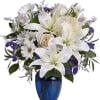 White lilies and daisies arranged in a blue vase