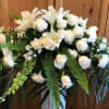 White floral spray with roses and lilies in a standing arrangement
