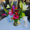 A mixed bouquet of bright and colorful blooms and textures in a