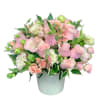 Pink roses and carnations arranged in a white vase