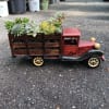 Wooden toy truck filled with assorted succulents