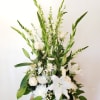 White floral arrangement in a white wicker basket