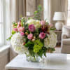 Pink roses and white hydrangeas in a clear glass vase