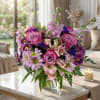 Pink and purple mixed bouquet in a clear glass vase