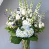 White and blue floral arrangement in a glass vase