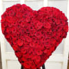 Heart-shaped arrangement of red roses on a stand