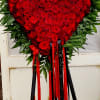 Heart-shaped red rose standing spray with red and black ribbons