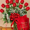Bouquet of red roses with a red ribbon in a glass vase